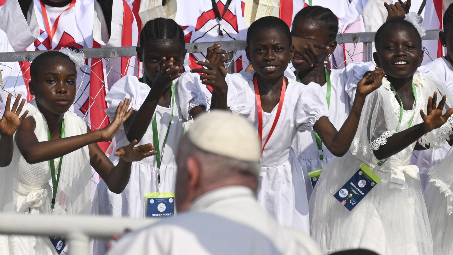 epa10442300 Young girls clap for Pope Francis upon his arrival, to celebrate Holy Mass, in the area of the Ndolo Airport in the Kinshasa city during the Apostolic Journey of His Holinass to the Democr ...