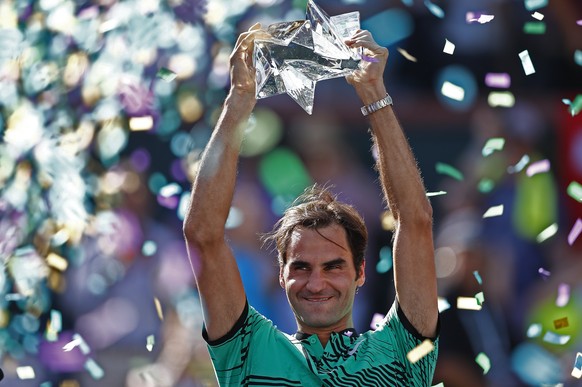epaselect epa05858982 Roger Federer of Switzerland holds the trophy after winning the final against Stan Wawrinka of Switzerland in their finals match at the 2017 BNP Paribas Open tennis tournament at ...
