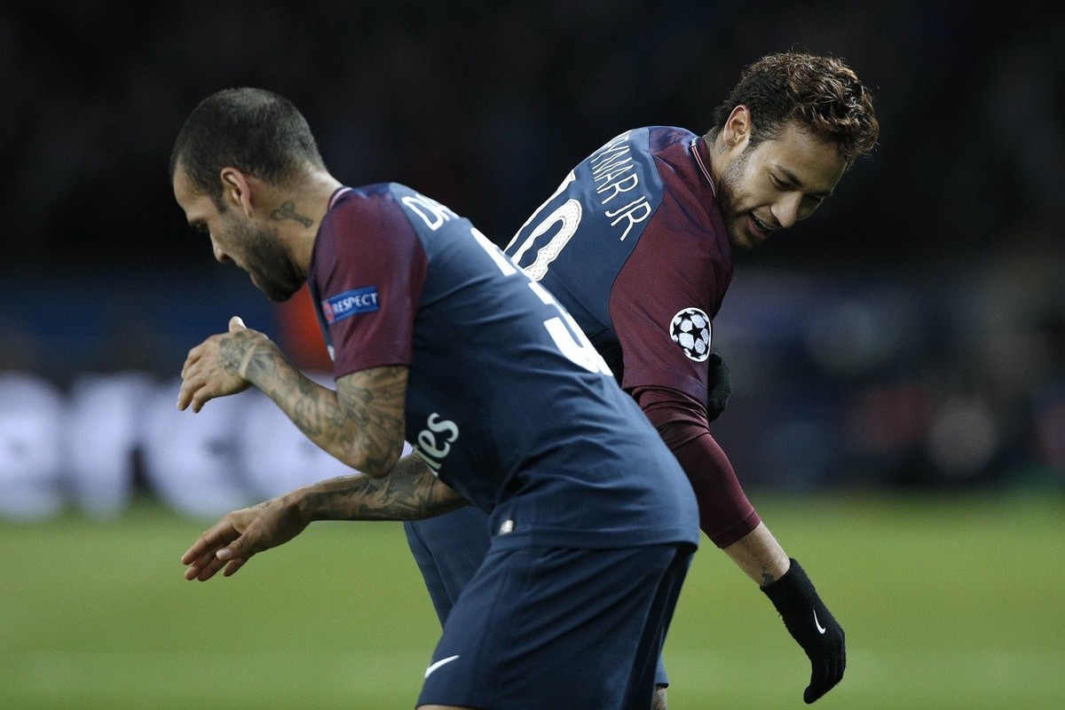 epa06344690 Dani Alves (L) of Paris Saint Germain celebrates with teammate Neymar (R) after scoring the 7-1 lead flanked by teammate Marquinhos (L) during the UEFA Champions League group B soccer matc ...