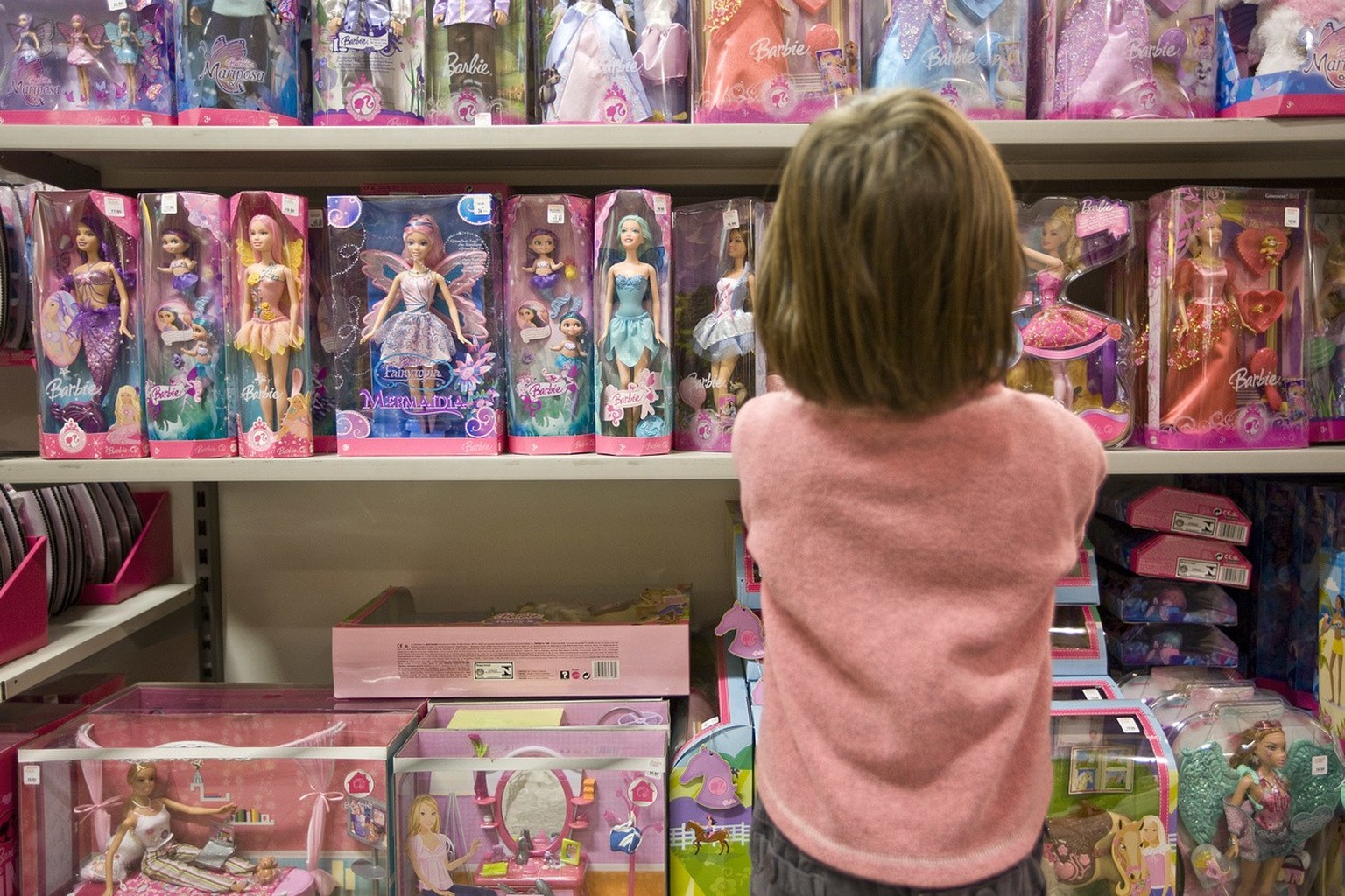 A girl decides on a barbie doll at a store of supermarket chain &quot;Migros&quot; at the Glattzentrum shopping mall in Wallisellen in the canton of Zurich, Switzerland, pictured on February 24, 2009. ...