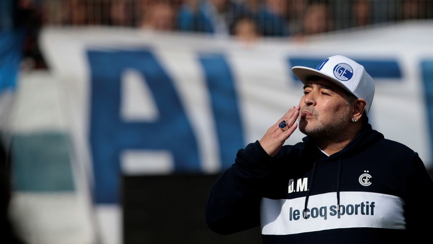 epa07828747 Diego Maradona greets the fans during his first training session as coach of Gimnasia y Esgrima La Plata, in an open-door event for club members at the Juan Carmelo Zerillo Stadium of La P ...