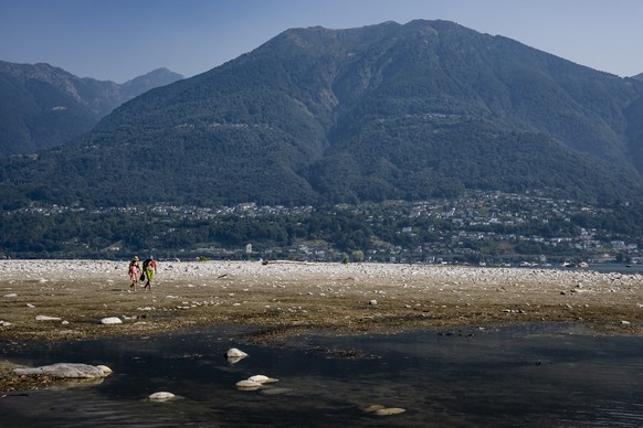 KEYPIX - People are taking advantage of the hot weather to walk along a sandbar formed by low water levels in the Maggia River delta at its mouth where it meets Lake Maggiore, in Locarno, Switzerland, ...