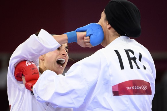 epa09402803 Elena Quirici, (L) of Switzerland competes in the women&#039;s karate kumite +61kg fight against Hamideh Abbasali of the Islamic Republic of Iran at the 2020 Tokyo Summer Olympics in Tokyo ...