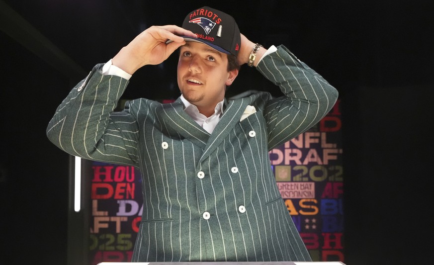 LSU offensive tackle Will Campbell puts on a hat after being chosen by the New England Patriots with the fourth overall pick during the first round of the NFL football draft, Thursday, April 24, 2025, ...