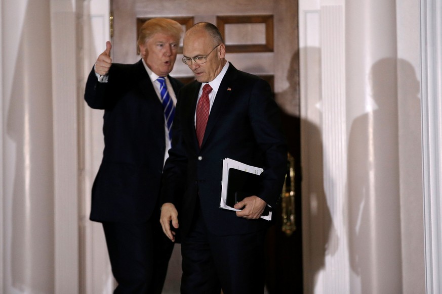 U.S. President-elect Donald Trump gestures as Andy Puzder, CEO of CKE Restaurants, departs after their meeting at the main clubhouse at Trump National Golf Club in Bedminster, New Jersey, U.S., Novemb ...