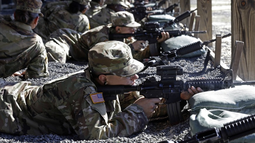 In this photo taken Wednesday, Aug. 17, 2016 U.S. Army Private Austin Lewis fires his M-4 weapon while participating in live-fire marksmanship training at Fort Jackson, S.C. While some of the Army&#03 ...