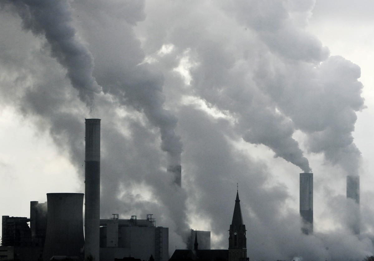 FILE - In this Feb. 25, 2008 file photo the tower of a church is pictured between the smoke billowing chimneys of the brown coal power plant Frimmersdorf in Grevenbroich near Duesseldorf, Germany. Aft ...