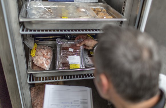 In a restaurant, a cantonal food inspector checks if all the food is labeled with a date, pictured on March 22, 2013, in Berne city, Switzerland. In Switzerland, the cantons are responsible for the im ...