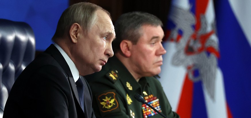 FILE Russian President Vladimir Putin, left, and Chief of the General Staff Gen. Valery Gerasimov attend a meeting with senior military officers in Moscow, Russia, Wednesday, Dec. 21, 2022. Russian Pr ...