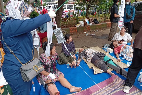People injured in an earthquake receive medical treatment in the parking lot of a hospital in Cianjur, West Java, Indonesia, Monday, November 21, 2022. An earthquake shook the Indonesian main island of Java on ...