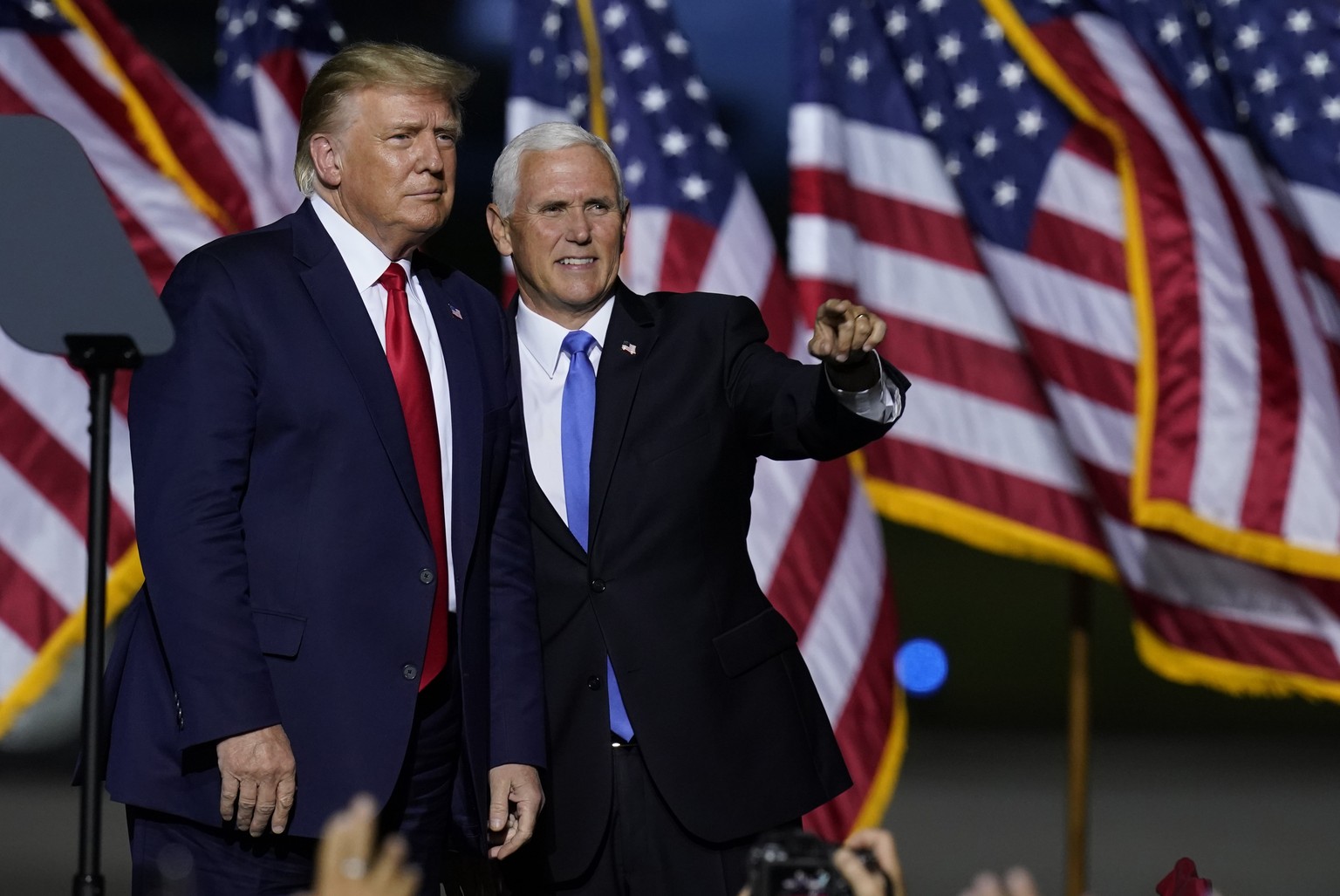 President Donald Trump, left, and Vice President Mike Pence look to the crowd during a campaign rally Friday, Sept. 25, 2020, in Newport News, Va. (AP Photo/Steve Helber)
Donald Trump,Mike Pence