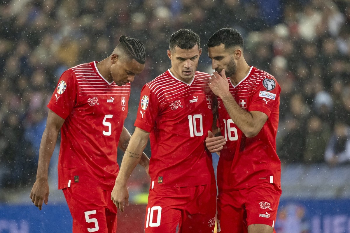 Switzerland's Manuel Akanji, Granit Xhaka, and Eray Coemert, from left, during the UEFA Euro 2024 qualifying group I soccer match between Switzerlandat and Kosovo at the St. Jakob-Park stadium in ...