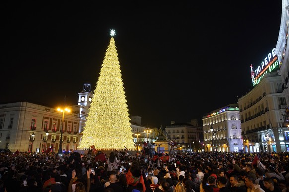 Morocco fans pack the central Puerta del Sol around an illuminated Christmas tree while celebrating in Madrid, Spain, Tuesday, Dec. 6, 2022. Morocco beat Spain on penalties during a round of 16 World  ...