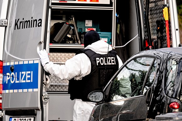 epa10353425 A police officer works during a raid in Berlin, Germany, 07 December 2022. Twenty-five people allegedly affiliated to the so-called Reichs Citizens (Reichsbuerger) movement were arrested i ...
