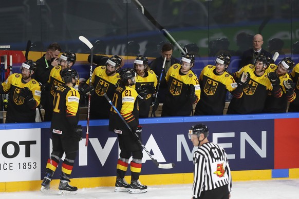 Germany players celebrate their first goal during the Ice Hockey World Championship group B match between Germany and Italy at the Arena in Riga, Latvia, Friday, May 21, 2021. (AP Photo/Sergei Grits)