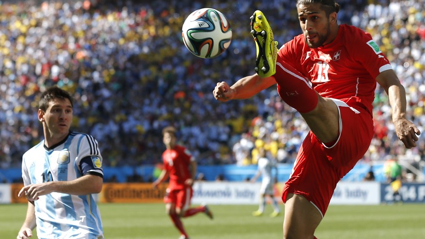 Switzerland&#039;s Ricardo Rodriguez, right, clears the ball from Argentina&#039;s Lionel Messi during the World Cup round of 16 soccer match between Argentina and Switzerland at the Itaquerao Stadium ...