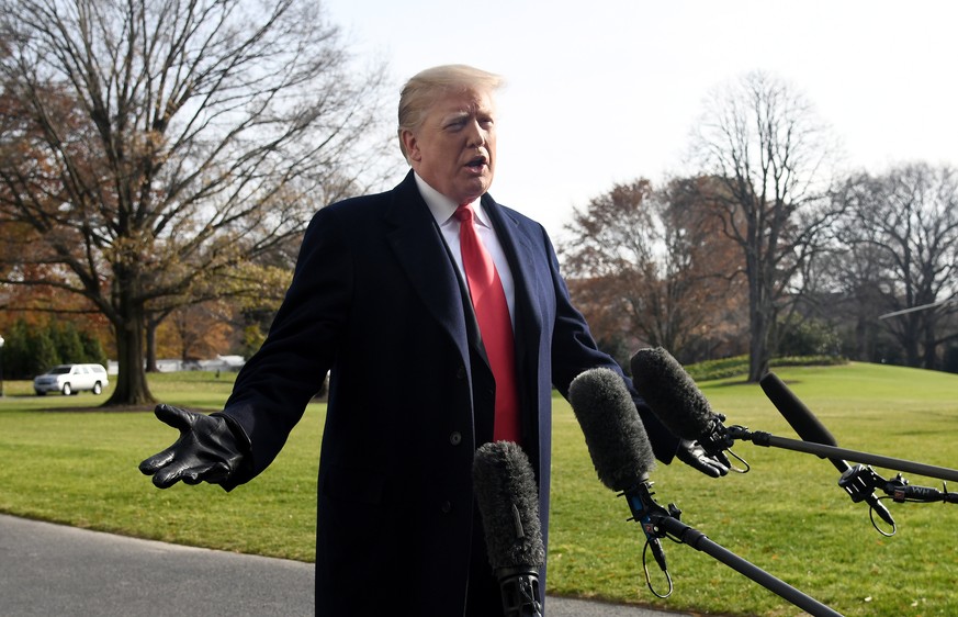 epa07218037 US President Donald J. Trump answers questions from the press while departing the White House in Washington, DC, USA, 08 December 2018. Trump said White House chief of staff John Kelly wil ...