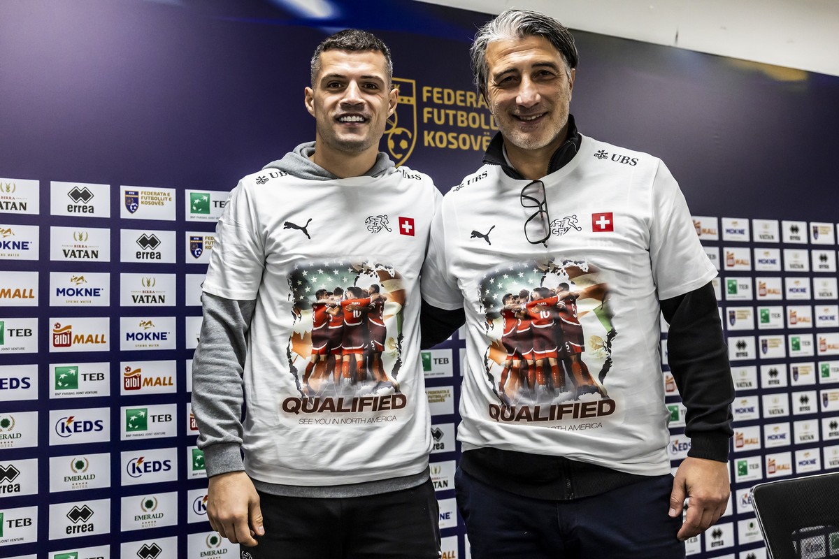 Switzerland's Granit Xhaka, left, and Switzerland's head coach Murat Yakin, right, wear T-shirt with the inscription "QUALIFIED, see you in North America" after Switzerland's  ...