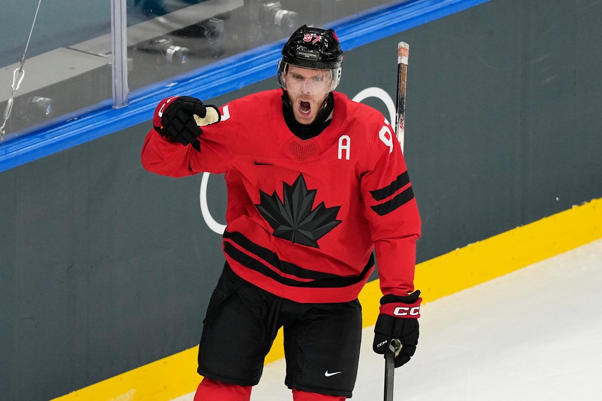 Canada's Connor McDavid celebrates after scoring his sides first goal during a preliminary round match of men's ice hockey between Canada and Switzerland at the 2026 Winter Olympics, in Mila ...