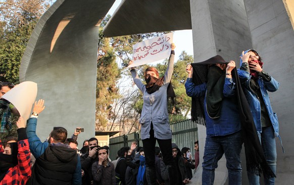 epa06410379 Iranian students clash with riot police during an anti-government protest around the University of Tehran, Iran, 30 December 2017. Media reported that illegal protest against the governmen ...