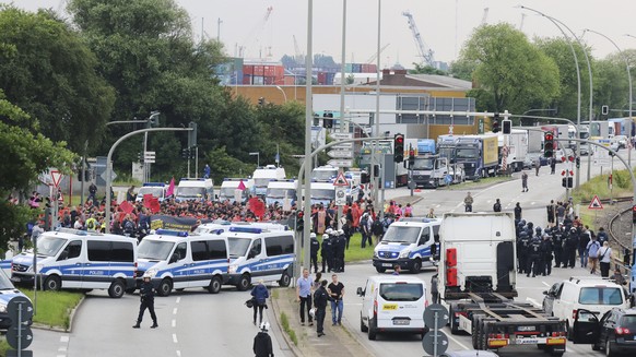 epa06071923 Protesters attend a demonstration at the Hamburg Harbour during the opening of the G20 summit in Hamburg, Germany, 07 July 2017. The G20 Summit (or G-20 or Group of Twenty) is an internati ...