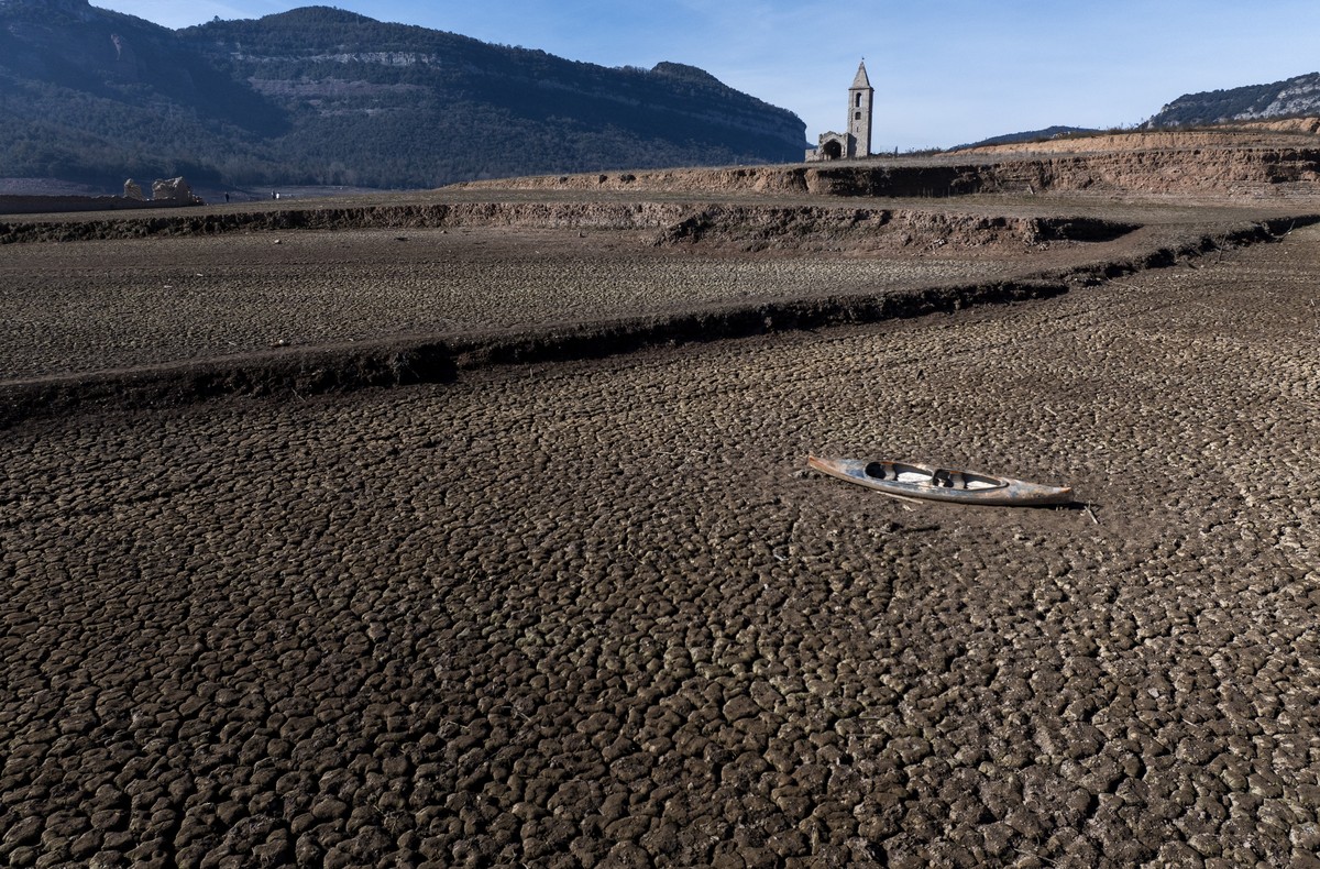 An abandoned canoe lies on the cracked ground at the Sau reservoir, which is only at 5 percent of its capacity, in Vilanova de Sau, about 100 km (62 miles) north of Barcelona, Spain, Friday, Jan. 26,  ...