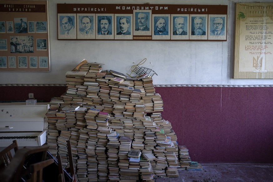 Russian and Ukrainian literature books remain stacked in a blast-damaged classroom ahead of this week&#039;s beginning of the academic year at Mykhailo-Kotsyubynske&#039;s lyceum, which was bombed by  ...