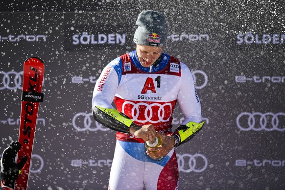 epa09543247 Marco Odermatt of Switzerland reacts on the podium after winning the men&#039;s Giant Slalom at the FIS Alpine Skiing World Cup season opener on the Rettenbach glacier in Soelden, Austria, ...
