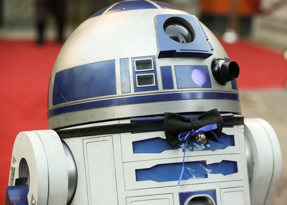 Film Star Wars character R2-D2 wears a black bow tie with gold wedding bands for the wedding of a couple of Australian Star Wars fans getting married at the forecourt of Hollywood&#039;s TCL Chinese ...