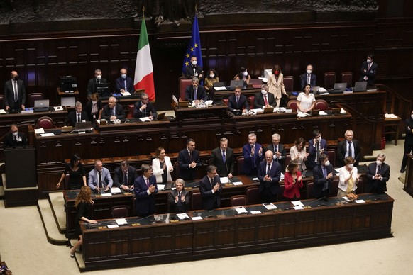 Italian Premier Mario Draghi, background center, delivers his speech at the Parliament in Rome, Thursday, July 21, 2022. Italian Premier Mario Draghi has won a confidence vote in the Senate, but boyco ...
