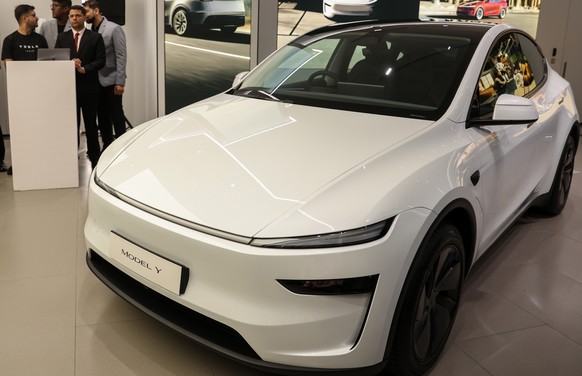 epa12238800 A Tesla Model Y car on display inside a newly inaugurated Tesla car showroom in Mumbai, India, 15 July 2025. The US car manufacturing company Tesla has opened its first showroom in the cou ...