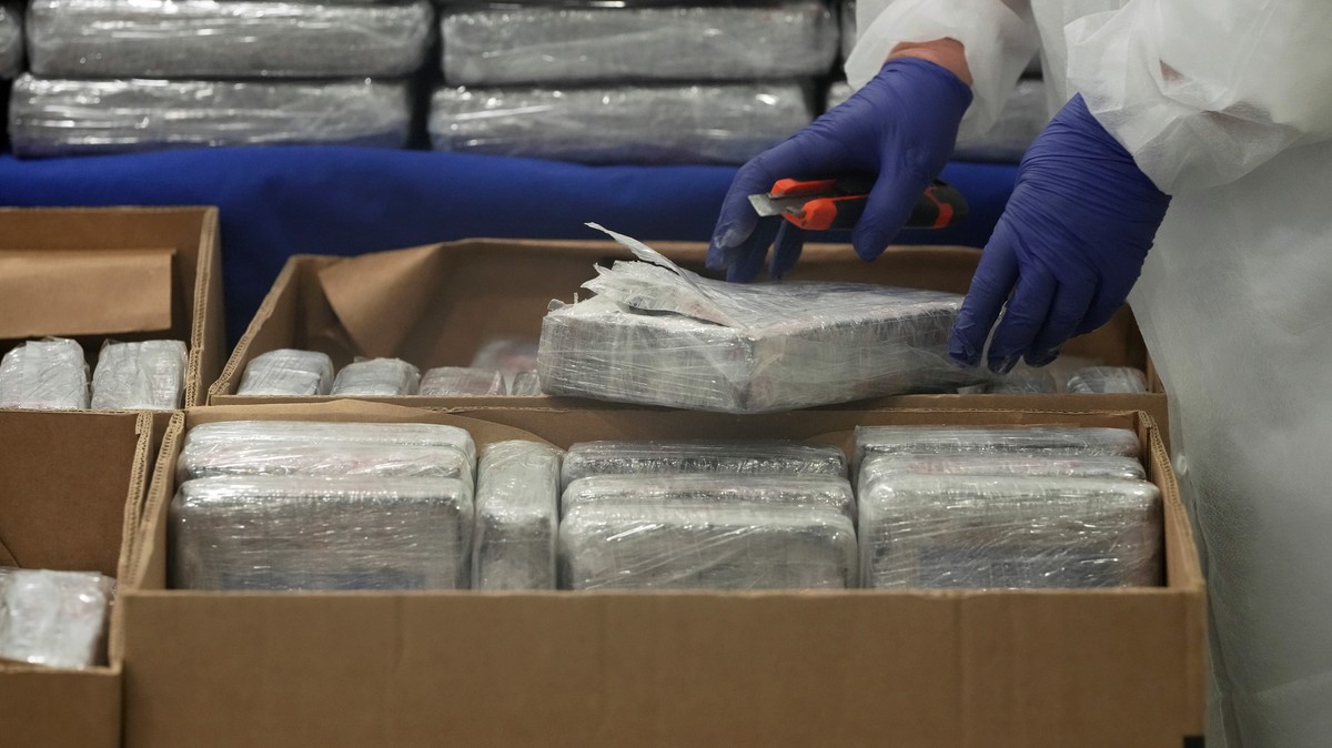 A member of the Portuguese police opens a packet of cocaine being displayed for the media at the police headquarters in Lisbon, Tuesday, May 2, 2023. Police said it seized 4.2 tons of cocaine that ent ...