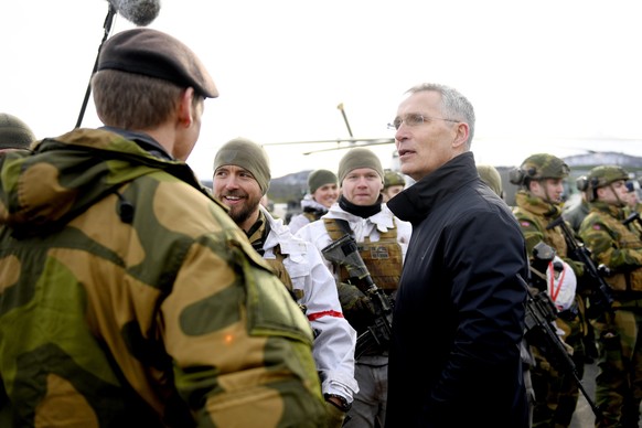 NATO Secretary General Jens Stoltenberg, right, greets soldiers during a visit to Bardufoss Military Airport, Norway March 25, 2022, in conjunction with the NATO Military Exercise Cold Response 22. (A ...