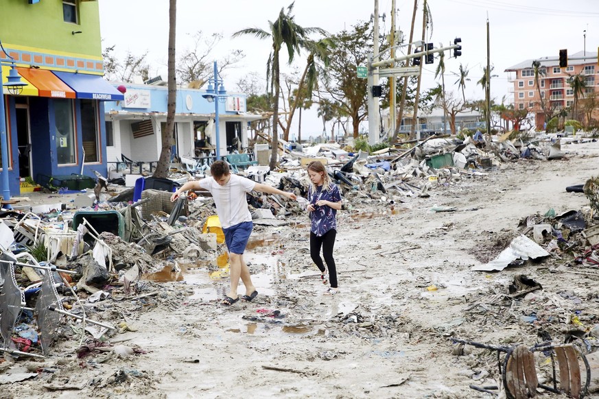 Jake Moses, 19, left, and Heather Jones, 18, of Fort Myers, explore a section of destroyed businesses at Fort Myers Beach, Fla., on Thursday, Sep 29, 2022, following Hurricane Ian. (Douglas R. Cliffor ...