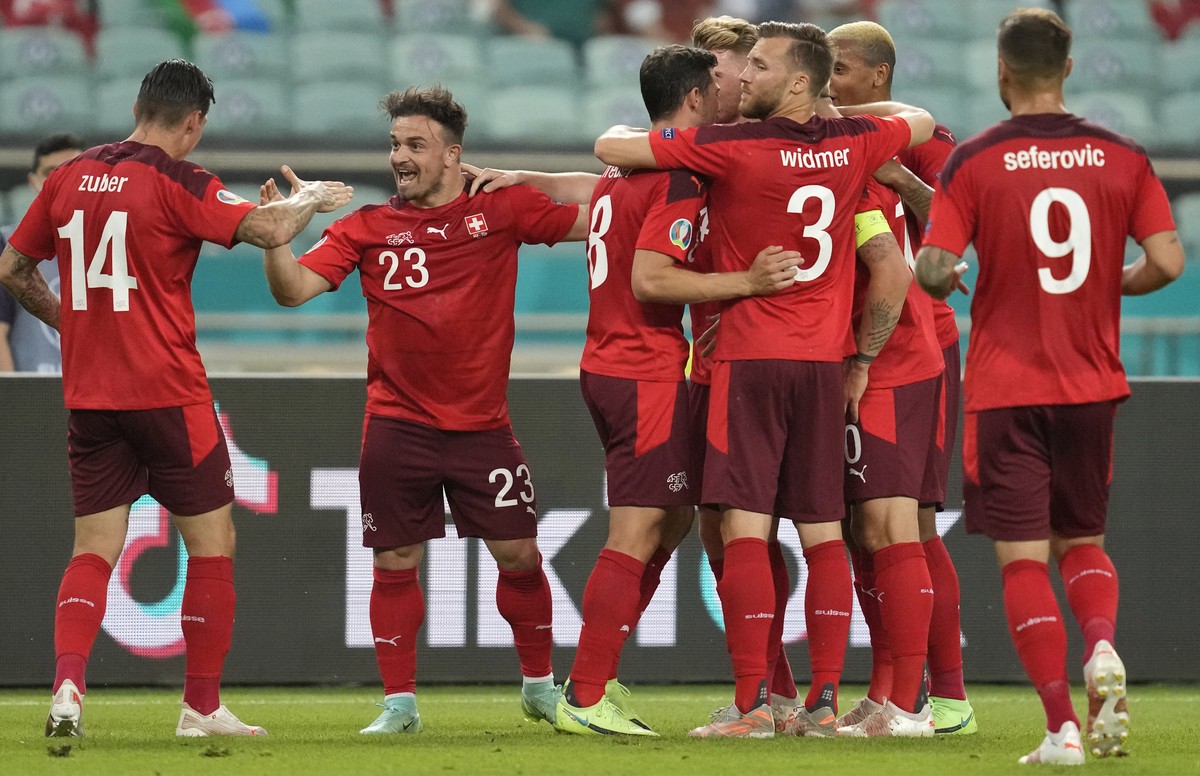 Switzerland's Xherdan Shaqiri, 2nd left, celebrates with teammates after scoring his sides second goal during the Euro 2020 soccer championship group A match between Switzerland and Turkey at the ...