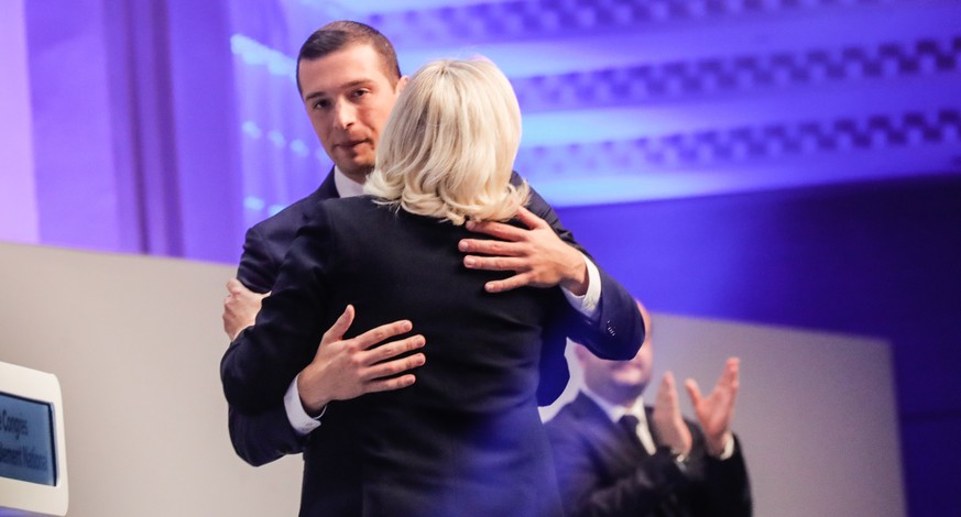 epa10287630 Jordan Bardella (L), newly elected president of France&#039;s far right Rassemblement National (RN) party, hugs Marine Le Pen, the party&#039;s former president, during the 18th RN party C ...