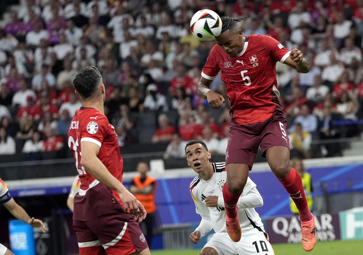 Switzerland's Manuel Akanji heads the ball during a Group A match between Switzerland and Germany at the Euro 2024 soccer tournament in Frankfurt, Germany, Sunday, June 23, 2024. (AP Photo/Martin ...