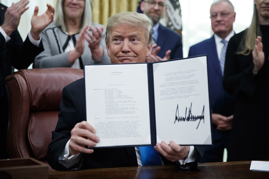 epa07381619 US President Donald J. Trump participates in a signing ceremony for Space Policy Directive 4 in the Oval Office of the White House in Washington, DC, USA, 19 February 2019. The policy dire ...