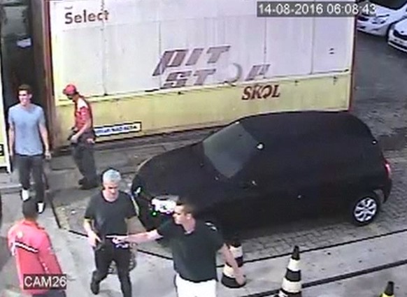 In this Sunday, Aug. 14, 2016 frame from surveillance video released by Brazil Police, swimmer Ryan Lochte, second from right, of the United States, and teammates, appear at a gas station during the 2 ...