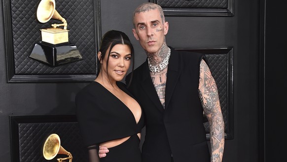 FILE - Kourtney Kardashian, left, and Travis Barker appear at the 64th Annual Grammy Awards in Las Vegas on April 3, 2022. TMZ was first to report Tuesday that the two married at a Las Vegas chapel ju ...