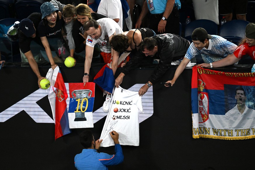 epa10428389 Novak Djokovic of Serbia signs autographs following his quarterfinal win over Andrey Rublev of Russia at the 2023 Australian Open tennis tournament in Melbourne, Australia, 25 January 2023 ...
