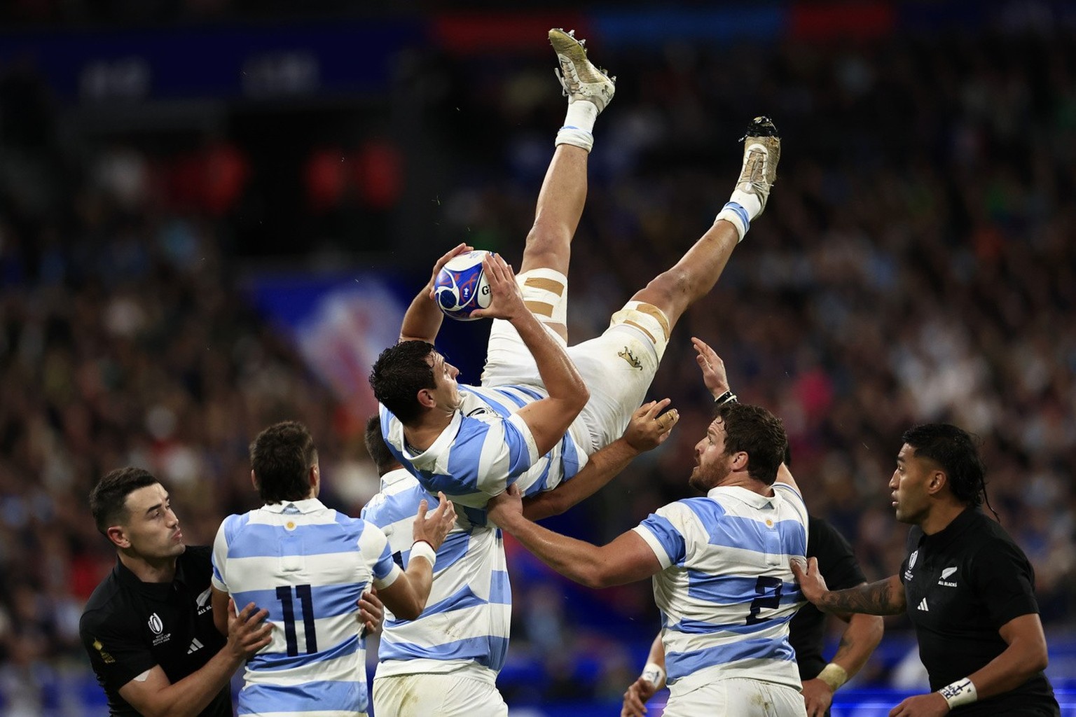 Argentina&#039;s Juan Martin Gonzalez, top, catches the ball during the Rugby World Cup semifinal match between Argentina and New Zealand at the Stade de France in Saint-Denis, outside Paris, Friday,  ...