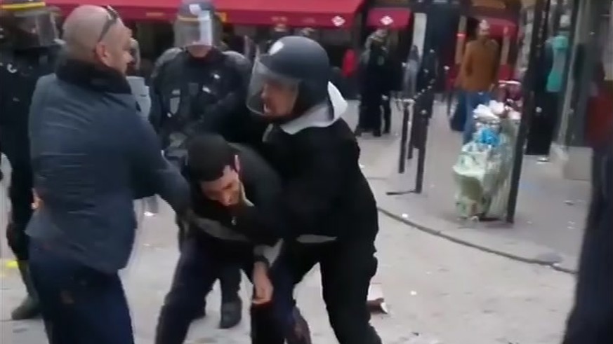 In this image taken from video, a man identified as Alexandre Benalla, right, a security chief to French President Emmanuel Macron, confronting a student during a May Day demonstration in Paris, May 1 ...
