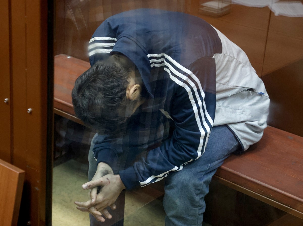 epa11241621 A suspect in the shooting attack on the Crocus City Hall concert venue sits inside a defendant's enclosure during a hearing on pretrial restrictions at Basmanny district court, in Mos ...