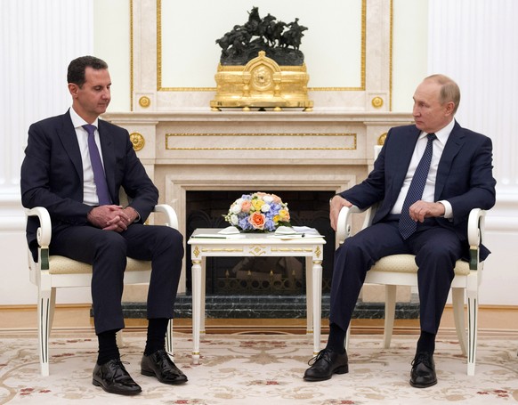 Russian President Vladimir Putin, right, listens to Syrian President Bashar Assad during their meeting in the Kremlin in Moscow, Russia, Monday, Sept. 13, 2021. (Mikhail Klimentyev, Sputnik, Kremlin P ...