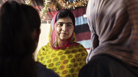 ADDS CREDIT TO HUMAN IN THE SIGNOFF - In this photo released on Sunday, July 12, 2015, by The Malala Fund, Nobel Peace Prize winner Malala Yousafzai, center, speaks with Syrian refugee girls during he ...