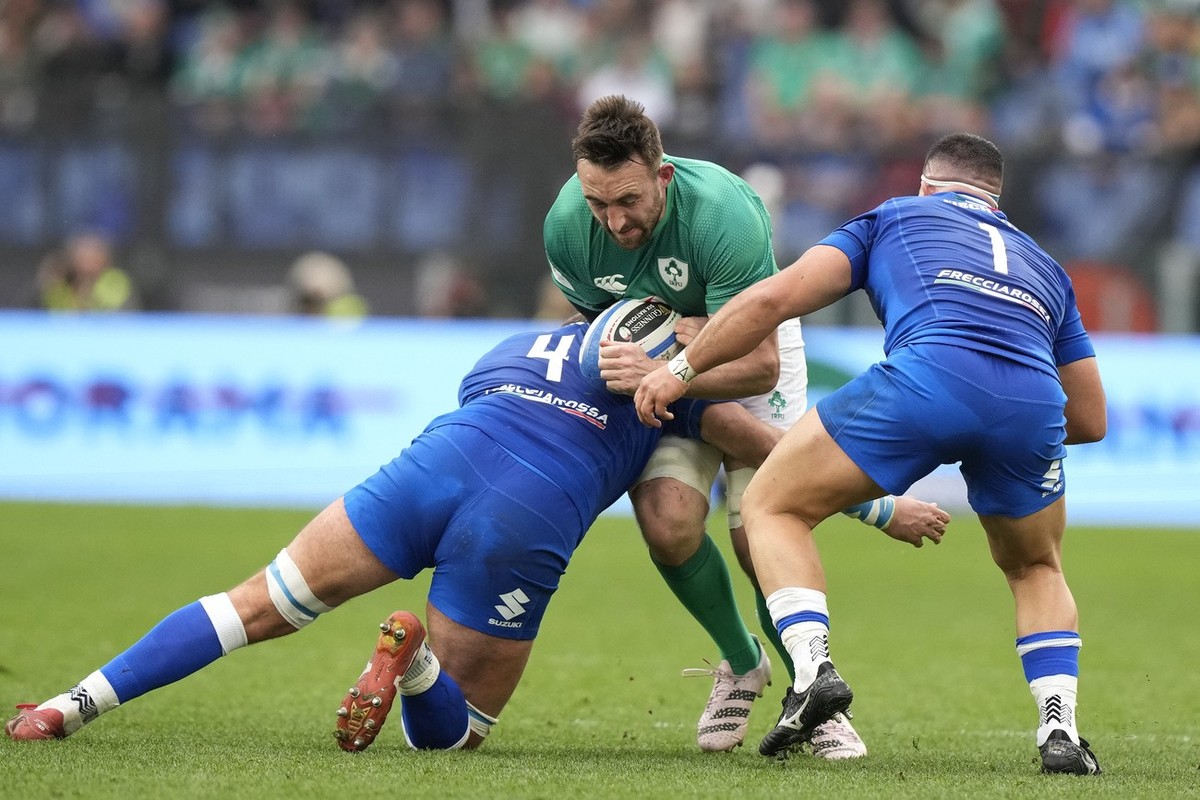 Ireland's Jack Conan is tackled by Italy's Niccolo Cannone, left, and Italy's Danilo Fischetti during the Six Nations rugby union international match between Italy and Ireland, at Rome& ...