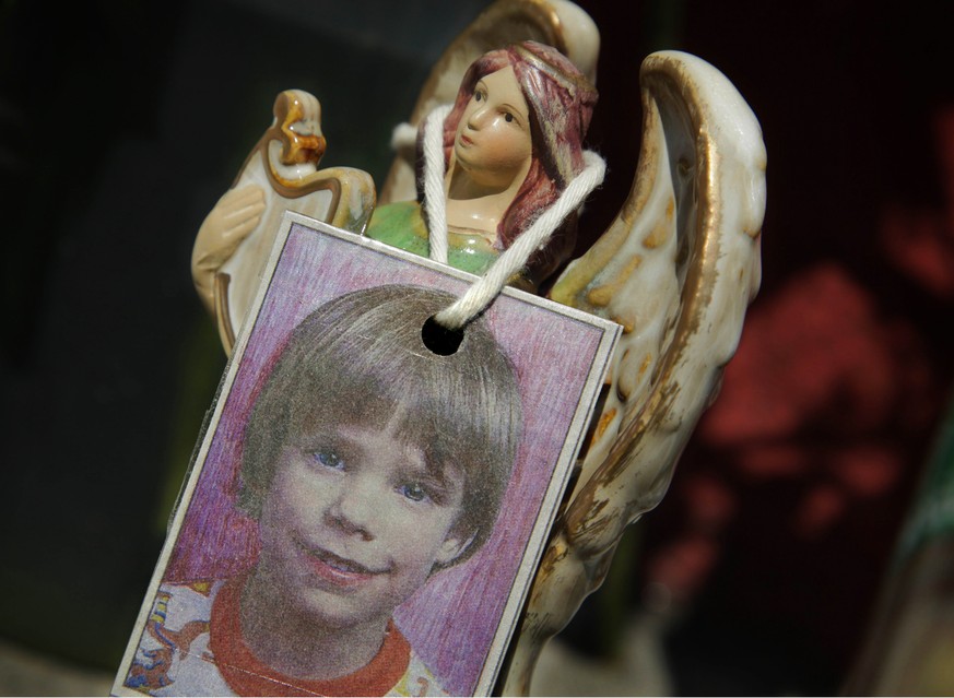 FILE- In this May 28, 2012 file photo, an image of Etan Patz hangs on an angel figurine, part of a makeshift memorial in the SoHo neighborhood of New York where the boy lived. Pedro Hernandez, a man u ...