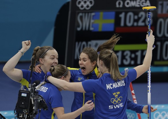Sweden celebrates after winning the gold medal in their women&#039;s curling final in the Gangneung Curling Centre at the 2018 Winter Olympics in Gangneung, South Korea, Sunday, Feb. 25, 2018. (AP Pho ...