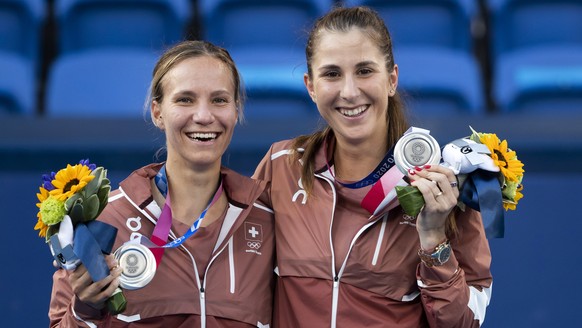 epa09384491 Belinda Bencic (R) and Viktorija Golubic of Switzerland pose with their silver medals on the podium after the women&#039;s tennis doubles gold medal match against Barbora Krejcikova and Ka ...